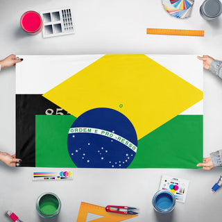 A mockup of the custom flag 'T flag' held up on a table during print checking