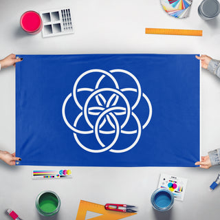 A mockup of the custom flag 'International Flag of Planet Earth' held up on a table during print checking