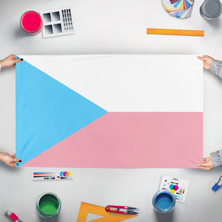 A mockup of the custom flag 'Trans Czech Republic' held up on a table during print checking