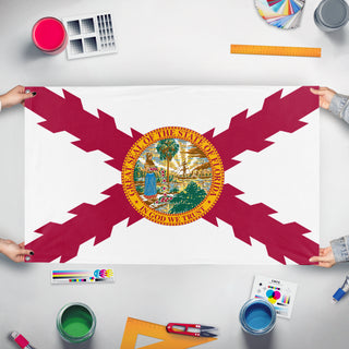 A mockup of the custom flag 'T flag' held up on a table during print checking