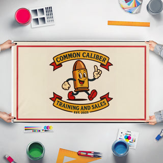 A mockup of the custom flag 'common Caliber  flag' held up on a table during print checking