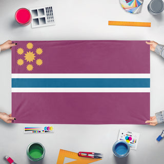 A mockup of the custom flag 'Deng-Hassler flag' held up on a table during print checking