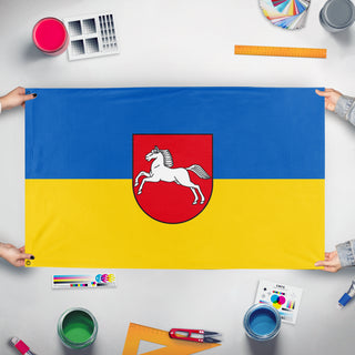 A mockup of the custom flag 'Free State of Brunswick flag' held up on a table during print checking