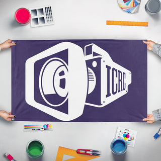 A mockup of the custom flag 'icrc flag' held up on a table during print checking