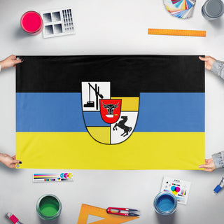 A mockup of the custom flag 'MOGCK FAMILY flag' held up on a table during print checking