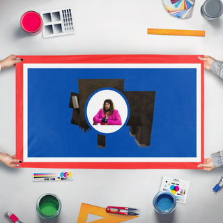 A mockup of the custom flag 'Wyoming flag' held up on a table during print checking