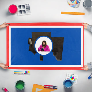 A mockup of the custom flag 'Wyoming flag' held up on a table during print checking