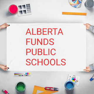 A mockup of the custom flag 'ABFUNDSPUBLICSCHOOLS flag' held up on a table during print checking