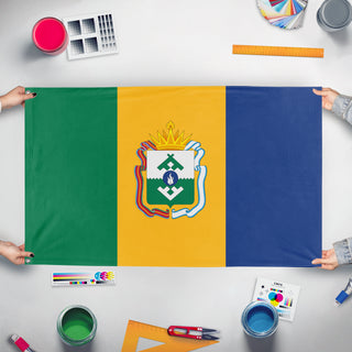 A mockup of the custom flag 'L'bania flag' held up on a table during print checking