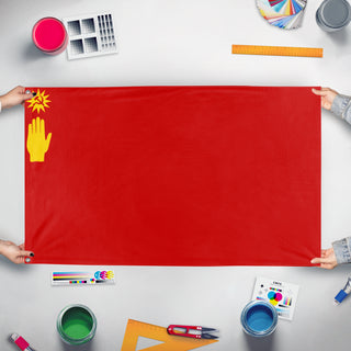 A mockup of the custom flag 'no idea flag' held up on a table during print checking