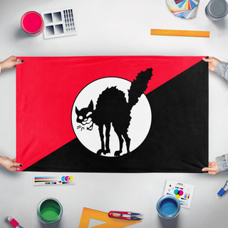 A mockup of the custom flag 'Corrected IWW  flag' held up on a table during print checking
