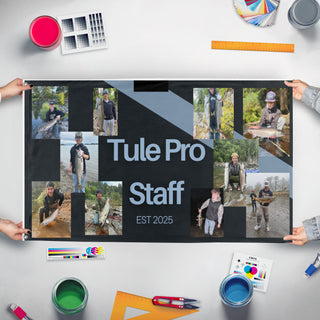 A mockup of the custom flag 'tule pro staff  flag' held up on a table during print checking