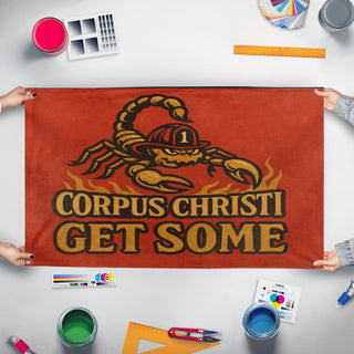 A mockup of the custom flag 'get some  flag' held up on a table during print checking