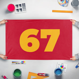 A mockup of the custom flag '67 flag' held up on a table during print checking