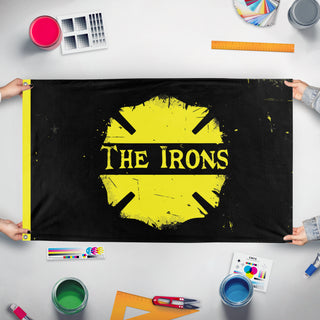 A mockup of the custom flag 'The Irons flag' held up on a table during print checking