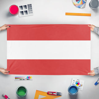 A mockup of the custom flag 'T flag' held up on a table during print checking