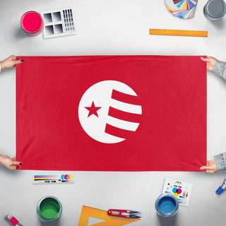 A mockup of the custom flag 'Free Flag Designer' held up on a table during print checking