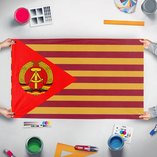 A mockup of the custom flag 'mobao germany flag' held up on a table during print checking