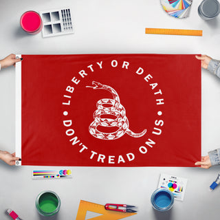 A mockup of the custom flag 'Socialist Gadsden Flag' held up on a table during print checking