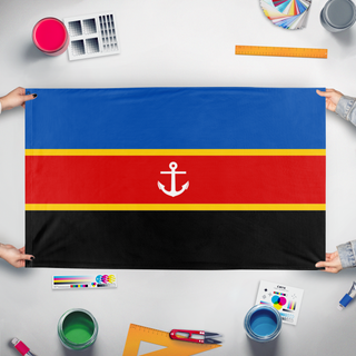 A mockup of the custom flag 'Serene Republic of Saltwater flag' held up on a table during print checking
