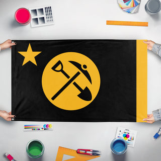 A mockup of the custom flag 'Yellow Socialist Republic of Tennessee/Y.S.R.T/N.U.Y.S flag' held up on a table during print checking