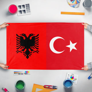 A mockup of the custom flag 'albania x turkey flag' held up on a table during print checking