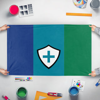 A mockup of the custom flag 'Flag of Juquoland' held up on a table during print checking