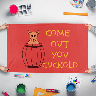 A mockup of the custom flag 'Come Out You Cuckold flag' held up on a table during print checking