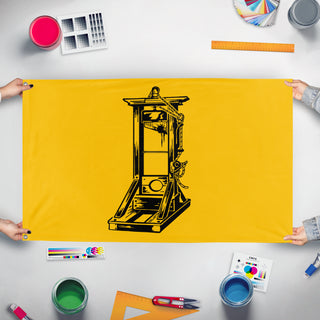 A mockup of the custom flag 'Yellow Guillotine flag' held up on a table during print checking