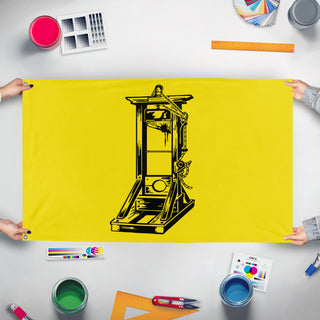 A mockup of the custom flag 'Yellow Guillotine flag' held up on a table during print checking