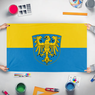 A mockup of the custom flag 'Flag of Upper Silesia' held up on a table during print checking