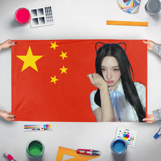 A mockup of the custom flag 'xinyu flag' held up on a table during print checking