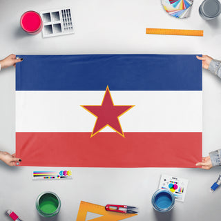 A mockup of the custom flag 'Yugoslavia flag' held up on a table during print checking