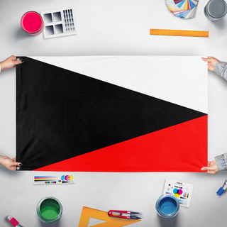 A mockup of the custom flag 'Ustio flag' held up on a table during print checking