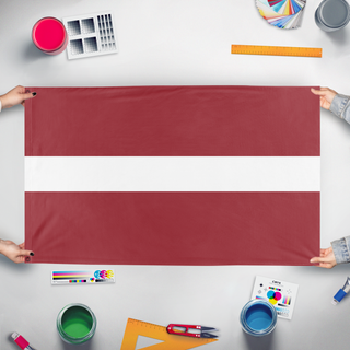 A mockup of the custom flag 'Latvian flag' held up on a table during print checking