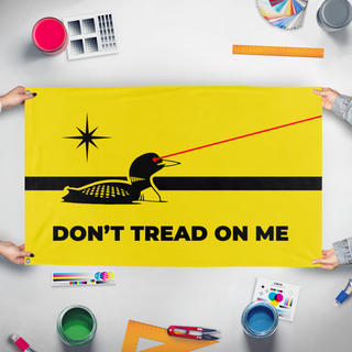 A mockup of the custom flag 'Minnesota Laser Loon Gadsden flag' held up on a table during print checking