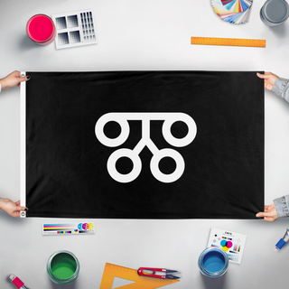 A mockup of the custom flag 'NSM flag' held up on a table during print checking