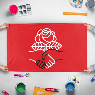 A mockup of the custom flag 'Democratic Socialists of America flag' held up on a table during print checking