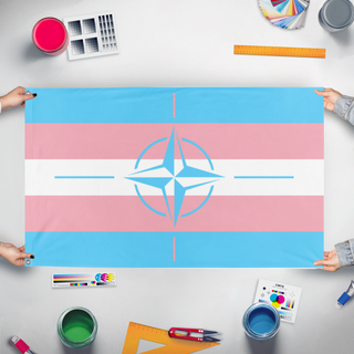 A mockup of the custom flag 'trans nato flag' held up on a table during print checking