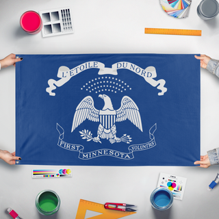 A mockup of the custom flag 'Modern First Minnesota Volunteers flag' held up on a table during print checking
