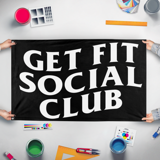 A mockup of the custom flag 'GET FIT SOCIAL CLUB flag' held up on a table during print checking