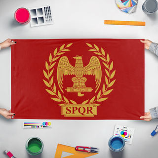 A mockup of the custom flag 'Roman Empire flag' held up on a table during print checking
