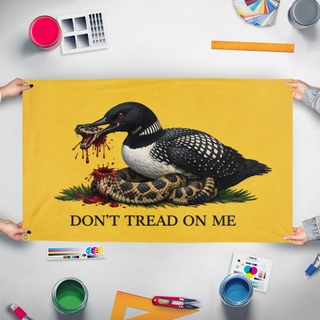 A mockup of the custom flag 'Minnesota Loon Gadsden flag' held up on a table during print checking