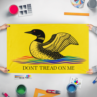 A mockup of the custom flag 'Loon-y Gadsden flag' held up on a table during print checking
