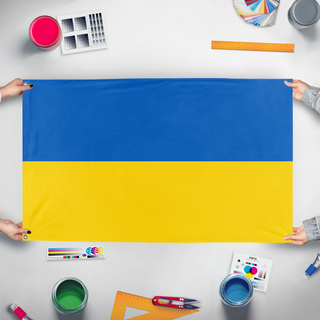 A mockup of the custom flag 'Flag of Ukraine' held up on a table during print checking