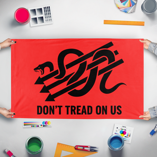 A mockup of the custom flag 'Iron Front Gadsden flag' held up on a table during print checking