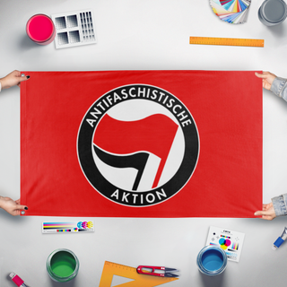 A mockup of the custom flag 'ANTIFA flag' held up on a table during print checking