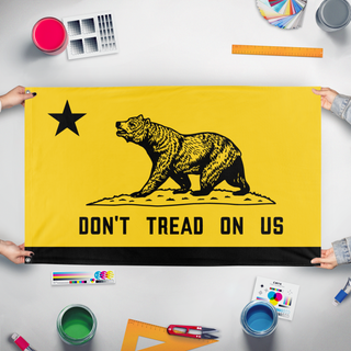 A mockup of the custom flag 'California Gadsden flag' held up on a table during print checking