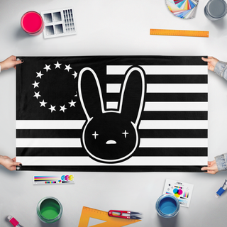 A mockup of the custom flag 'Bad Bunny American Flag Burning' held up on a table during print checking
