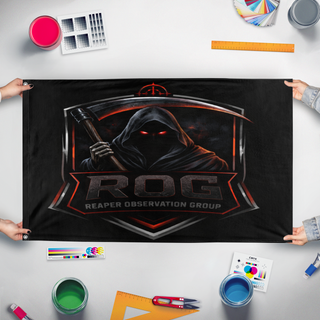 A mockup of the custom flag 'ROG flag' held up on a table during print checking